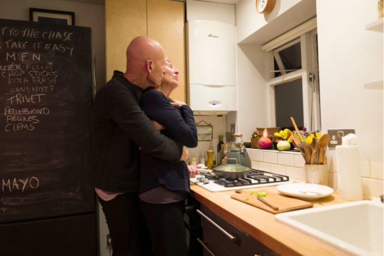 Older man and wife in kitchen